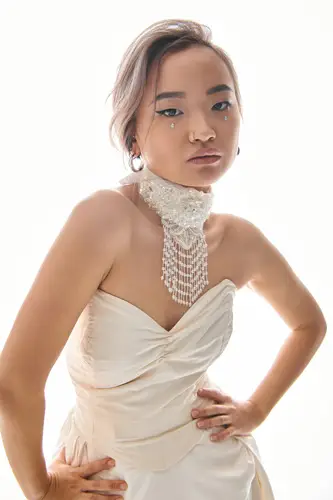 confident asian young bride in elegant necklace and dress posin