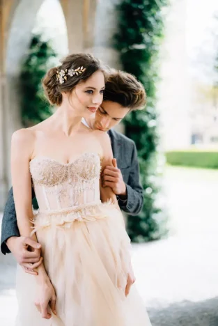 groom-hugs-bride-from-behind-and-kisses-model-couples-network